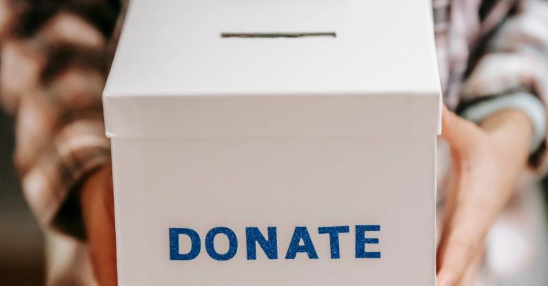 Responsive Benefits - Crop anonymous person showing donation box