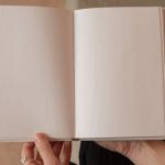 Brand Story - Woman holding book with blank pages