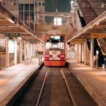 Social Platforms - A train is traveling through a train station at night