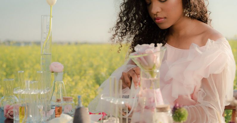 AB Testing - Young Woman in Airy Summer Dress Creating Perfumes in Flower Field Laboratory