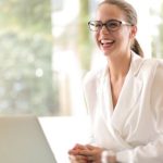 Analytics Content - Laughing businesswoman working in office with laptop
