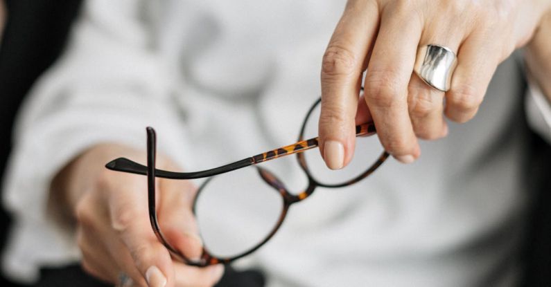 E-commerce Analytics - Person Holding Brown Framed Eyeglasses